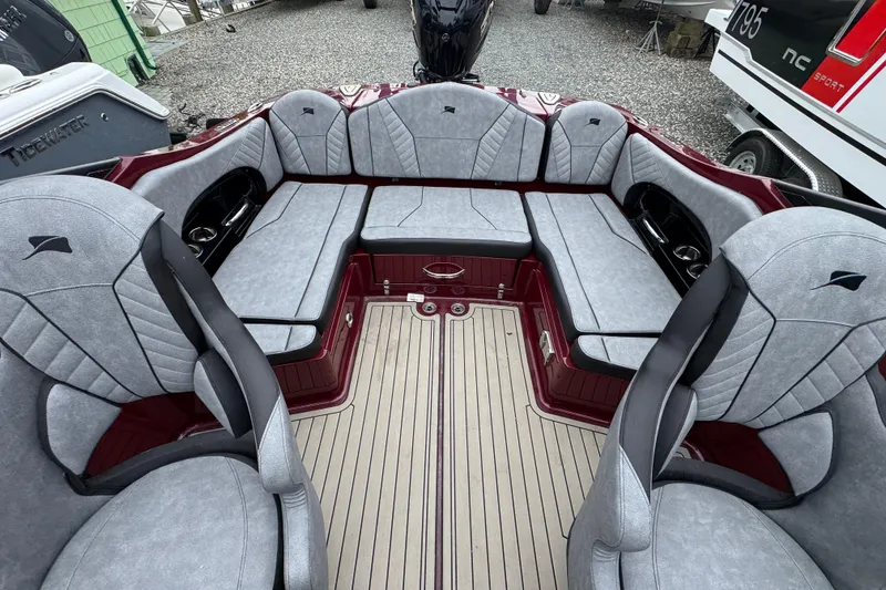 Slide: The Image of Interior of 2026 Stingray 23 OCX boat with gray seating and red accents. - 31