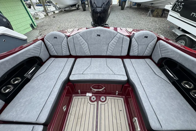 Slide: The Image of Luxurious seating area of 2026 Stingray 23 OCX boat with gray upholstery and cup holders. - 33