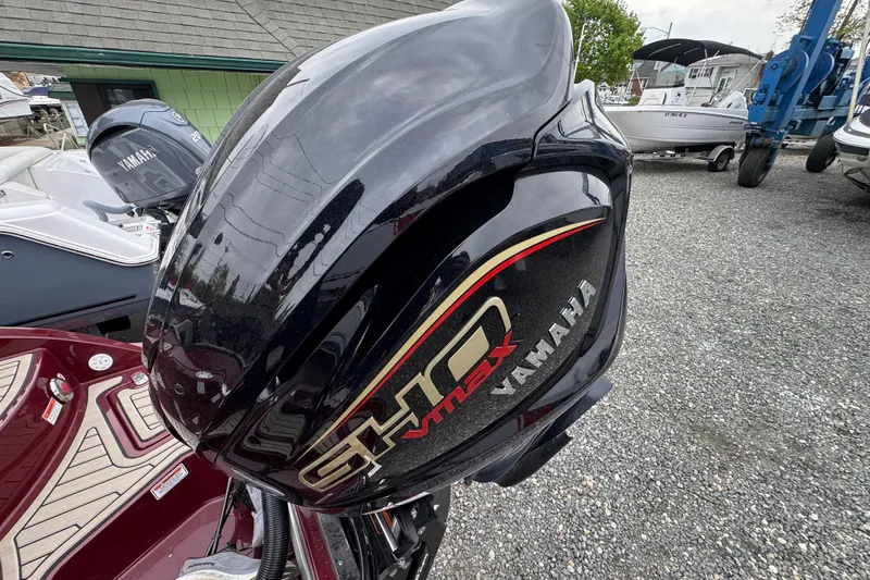 Slide: The Image of Yamaha VMAX outboard motor on a 2026 Stingray 23 OCX boat, parked outdoors. - 34