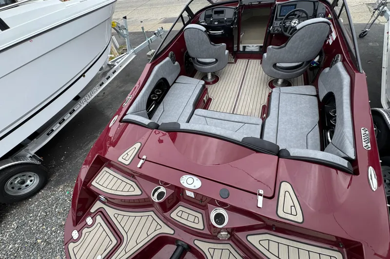 Slide: The Image of 2026 Stingray 23 OCX boat with sleek maroon design and luxurious seating. - 37