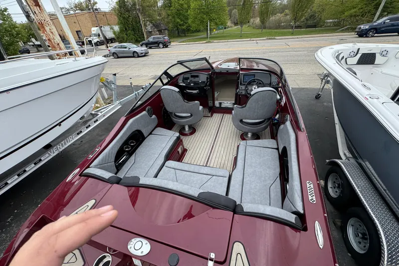 Slide: The Image of 2026 Stingray 23 OCX boat interior with gray seating and modern dashboard. - 38