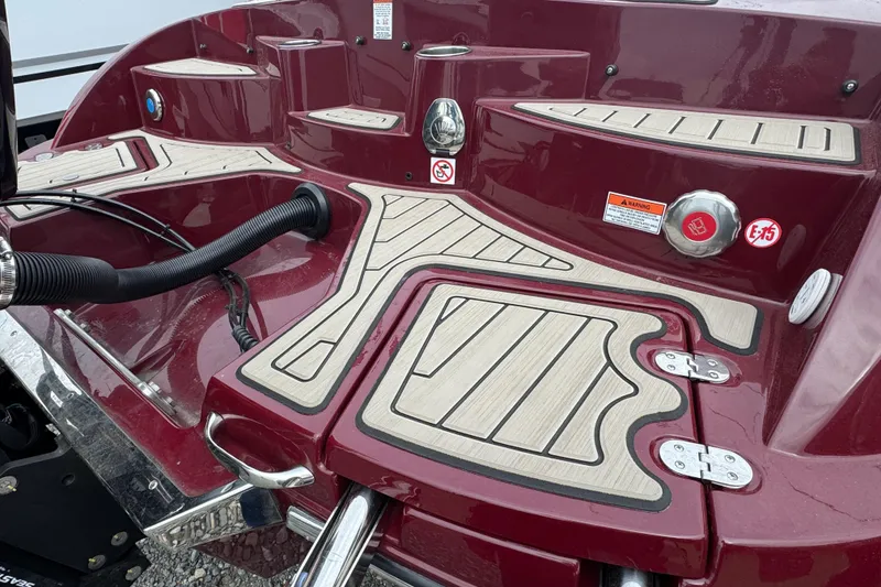 Slide: The Image of 2026 Stingray 23 OCX boat deck with maroon finish and non-slip flooring. - 5