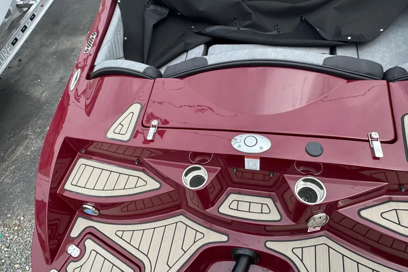 Slide: The Image of 2026 Stingray 23 OCX boat with red exterior and beige deck accents. - 6
