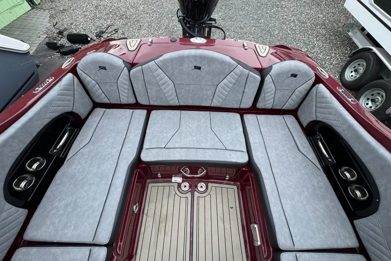 Slide: The Image of 2026 Stingray 23 OCX boat interior with gray cushioned seating and red accents. - 8