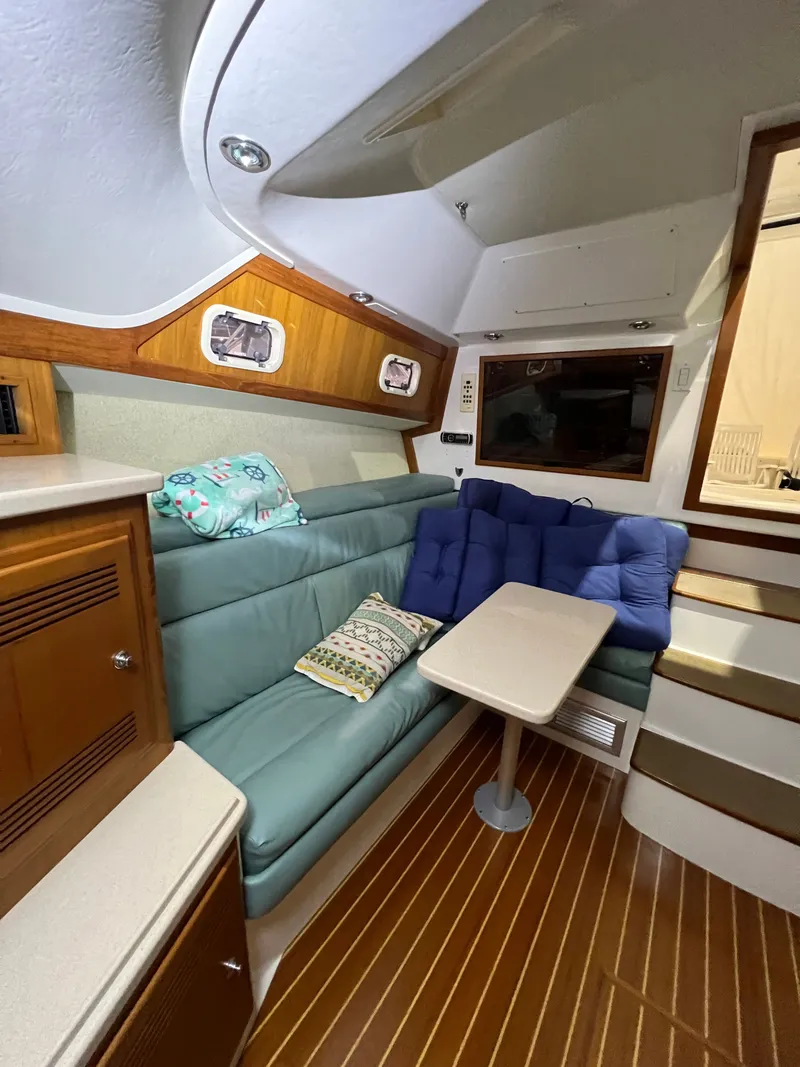 Slide: The Image of Interior of a 1998 Cabo 35 Express yacht with cozy seating area. - 19