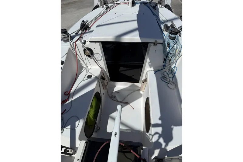Slide: The Image of 1990 Corsair F 27 sailboat cockpit with ropes and open hatch. - 12