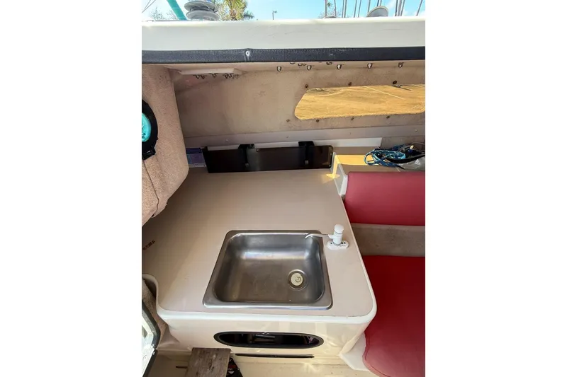 Slide: The Image of Interior of a 1990 Corsair F 27 sailboat featuring a compact kitchenette with a sink. - 8
