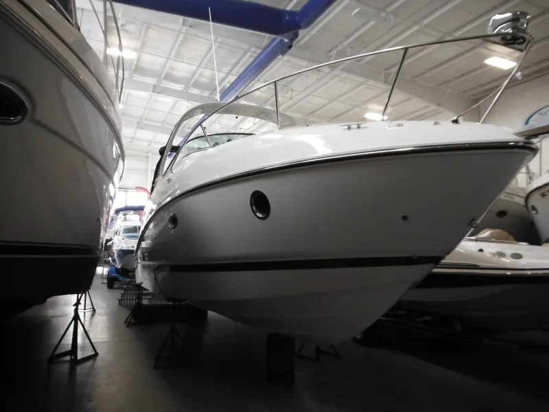 The Image of 2014 Rinker 290 Express Cruiser in a boat showroom. - 0