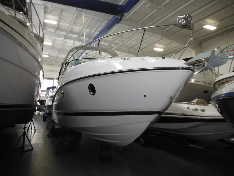 Slide: The Image of 2014 Rinker 290 Express Cruiser in a storage facility. - 12