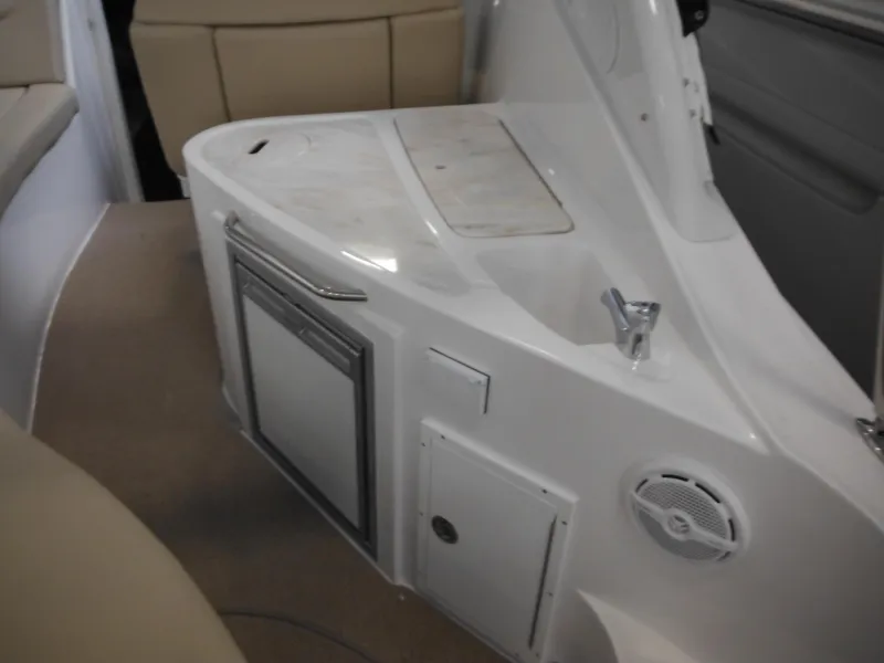 Slide: The Image of Interior of 2014 Rinker 290 Express Cruiser with fridge and sink. - 13