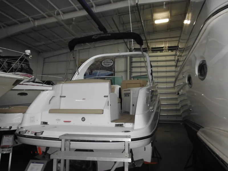 Slide: The Image of 2014 Rinker 290 Express Cruiser in a storage facility. - 14