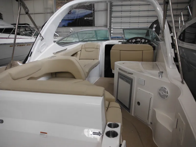 Slide: The Image of Interior of 2014 Rinker 290 Express Cruiser with beige seating. - 15