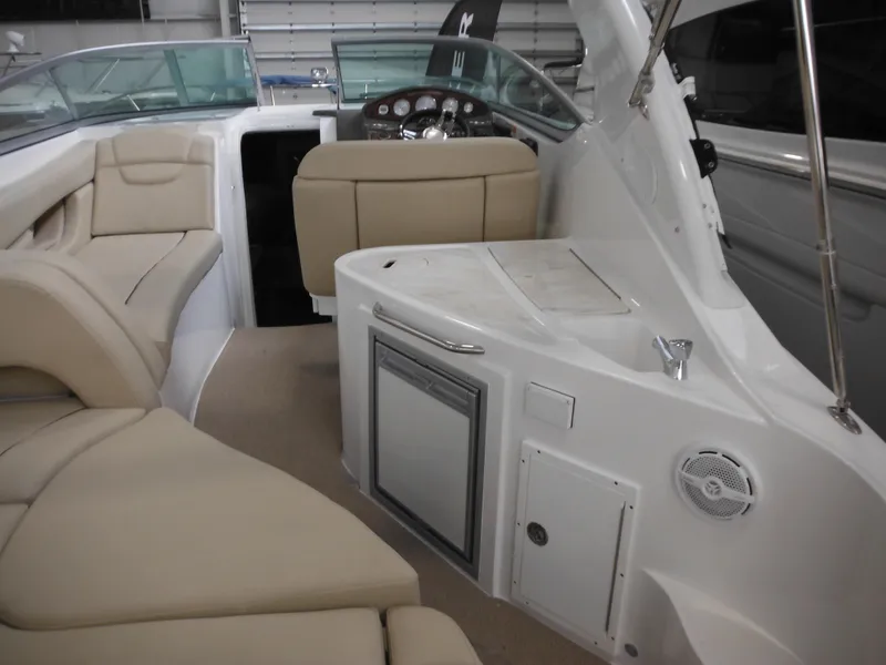 Slide: The Image of Interior of 2014 Rinker 290 Express Cruiser with beige seating. - 17