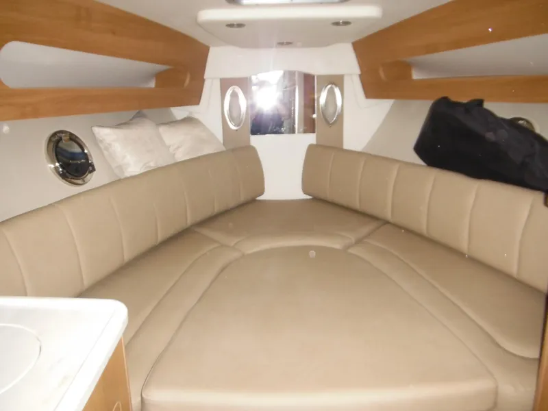 Slide: The Image of Interior of 2014 Rinker 290 Express Cruiser with beige seating. - 20