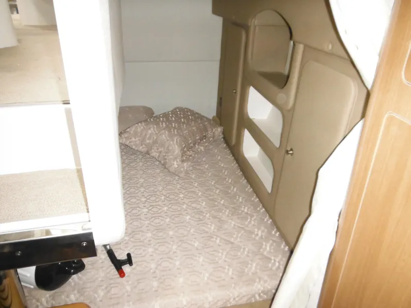 Slide: The Image of Interior of 2014 Rinker 290 Express Cruiser with bed and storage. - 23