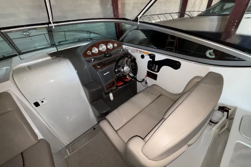 Slide: The Image of 2014 Rinker 290 Express Cruiser helm with steering wheel and instrument panel. - 30
