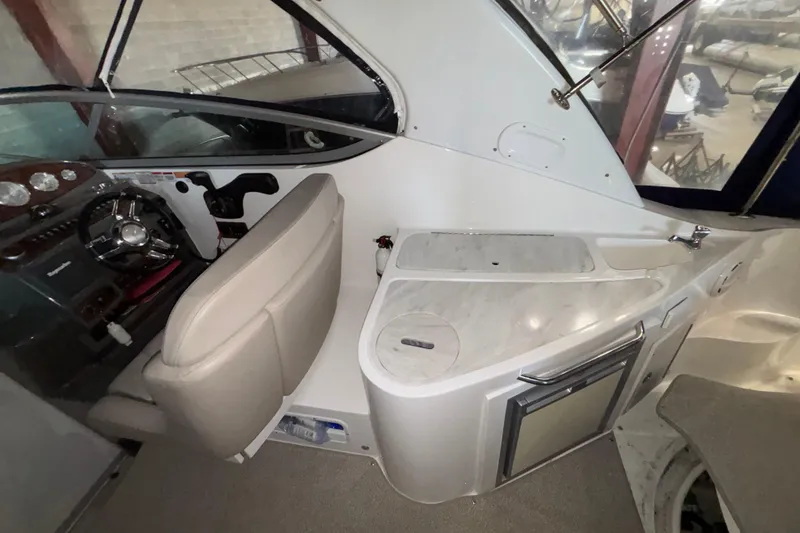 Slide: The Image of 2014 Rinker 290 Express Cruiser helm with steering wheel and control panel. - 31