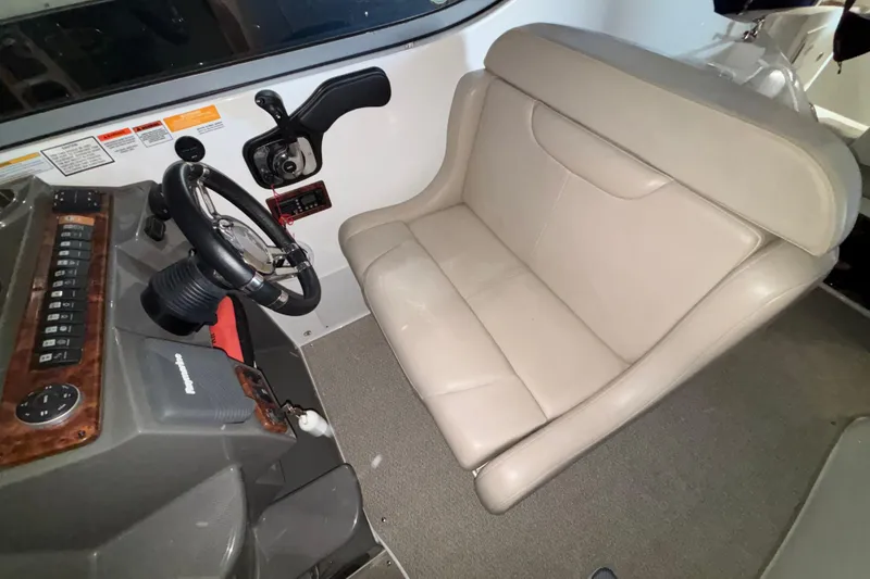 Slide: The Image of Interior of 2014 Rinker 290 Express Cruiser showing helm and beige seating. - 35
