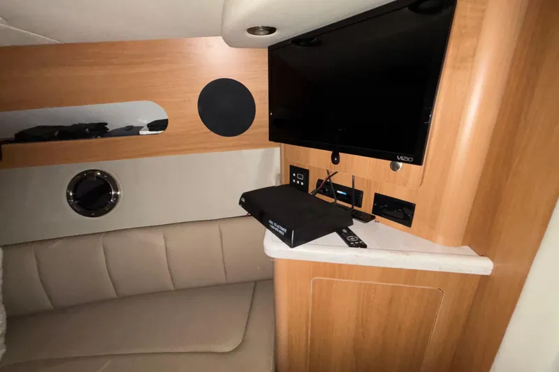 Slide: The Image of Interior of 2014 Rinker 290 Express Cruiser with TV and seating area. - 38