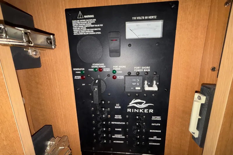 Slide: The Image of Control panel of a 2014 Rinker 290 Express Cruiser, featuring power and generator switches. - 41