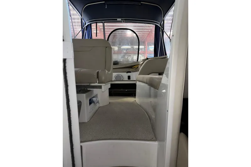 Slide: The Image of Interior view of 2014 Rinker 290 Express Cruiser boat with seating and canopy. - 43