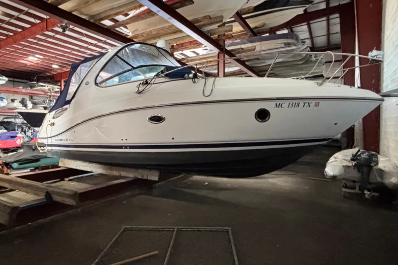 Slide: The Image of 2014 Rinker 290 Express Cruiser in indoor storage, side view. - 48