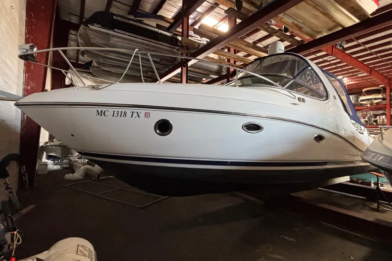 Slide: The Image of 2014 Rinker 290 Express Cruiser in indoor storage facility. - 49