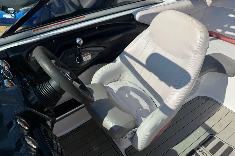 Slide: The Image of 2005 MasterCraft XStar boat interior with steering wheel and captain's seat. - 10