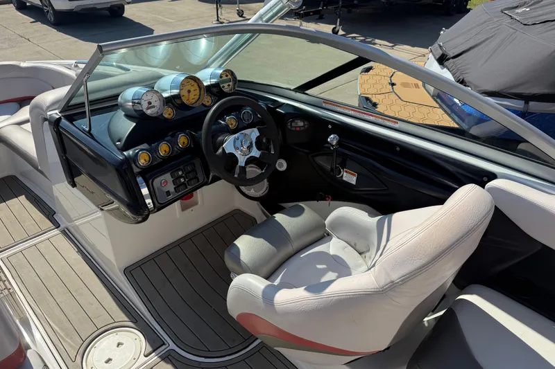 Slide: The Image of 2005 MasterCraft XStar boat interior with steering wheel and dashboard gauges. - 12
