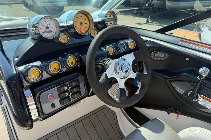 Slide: The Image of 2005 MasterCraft XStar dashboard with gauges and steering wheel. - 13