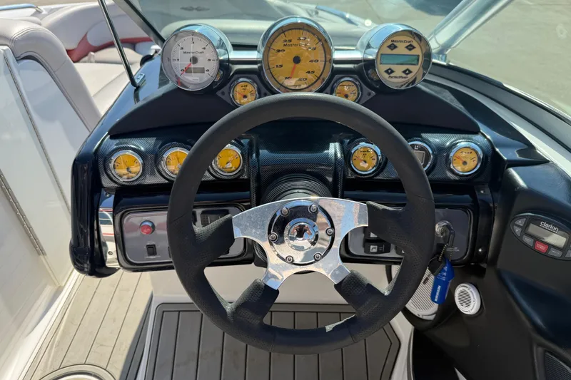 Slide: The Image of 2005 MasterCraft XStar dashboard with steering wheel and gauges. - 14
