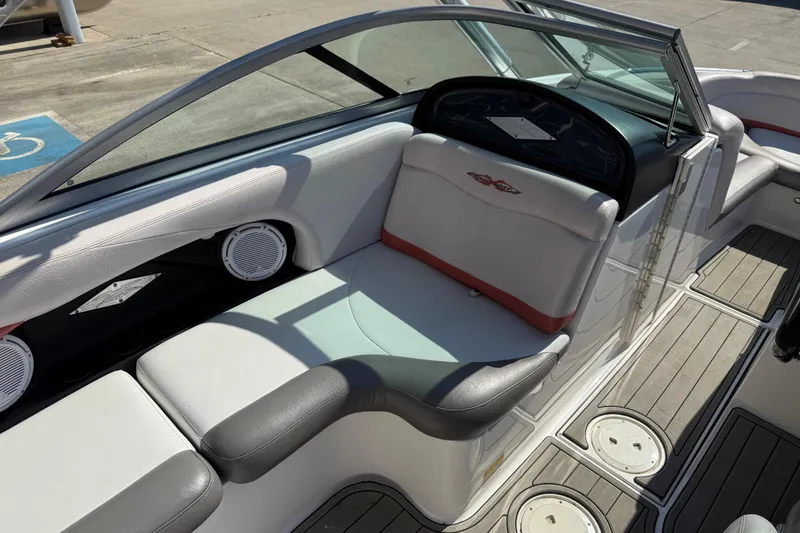 Slide: The Image of 2005 MasterCraft XStar boat interior with white and gray seating, dashboard, and speakers. - 15