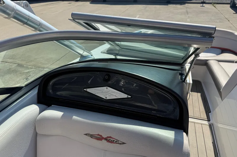Slide: The Image of 2005 MasterCraft XStar boat interior with open windshield and seating area. - 16