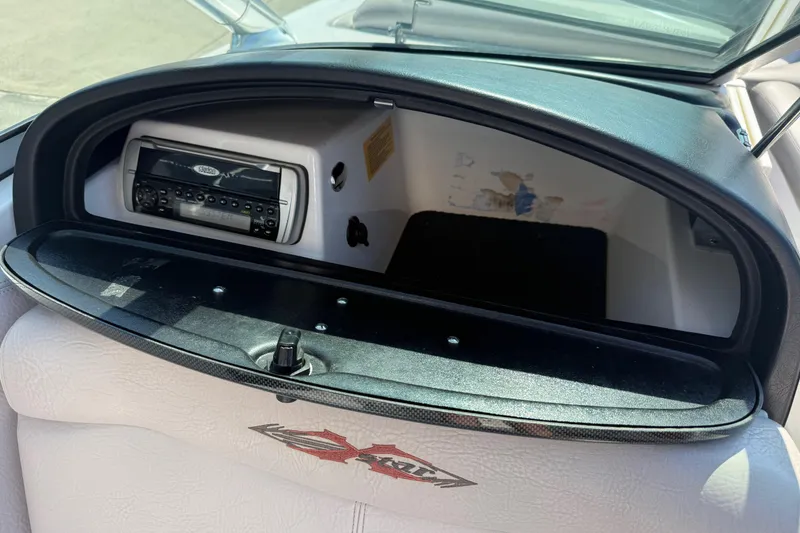 Slide: The Image of 2005 MasterCraft XStar boat dashboard with stereo system and storage compartment. - 17