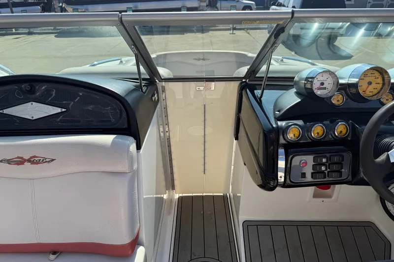 Slide: The Image of 2005 MasterCraft XStar boat dashboard with gauges and steering wheel. - 18