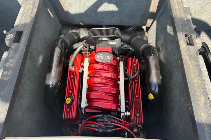 Slide: The Image of 2005 MasterCraft XStar engine with red components and MCX branding. - 20
