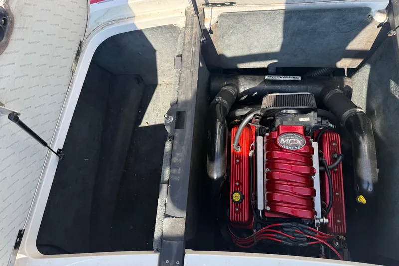 Slide: The Image of 2005 MasterCraft XStar engine compartment with red MCX engine. - 21
