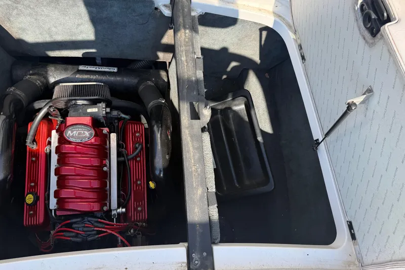 Slide: The Image of 2005 MasterCraft XStar engine compartment with red MCX engine. - 22