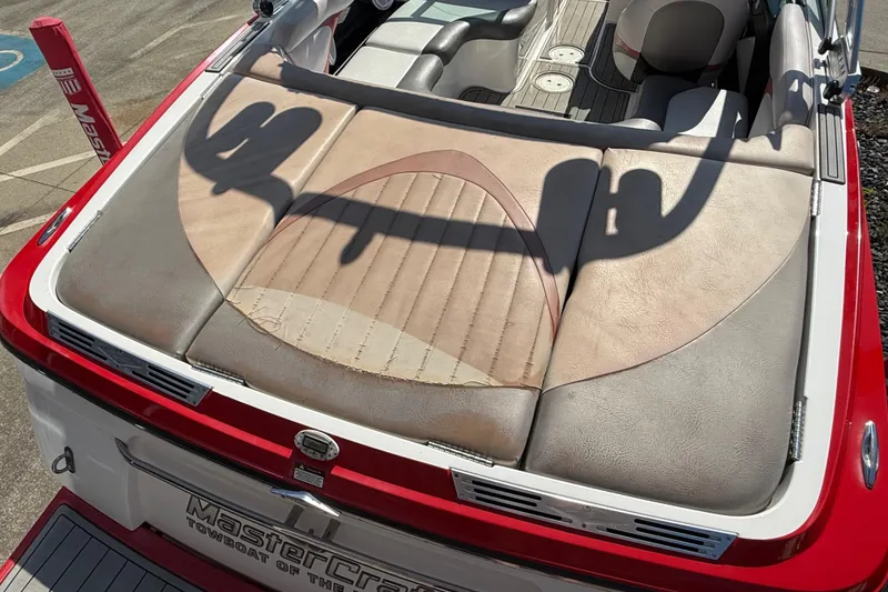 Slide: The Image of 2005 MasterCraft XStar boat interior with worn upholstery and red exterior detailing. - 29