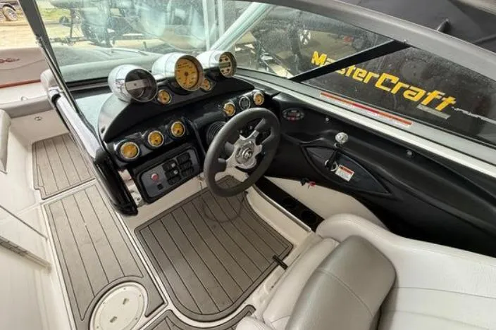 Slide: The Image of 2005 MasterCraft XStar boat interior with steering wheel, gauges, and seating. - 5