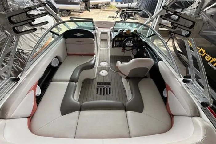 Slide: The Image of 2005 MasterCraft XStar boat interior with spacious seating and modern dashboard design. - 6