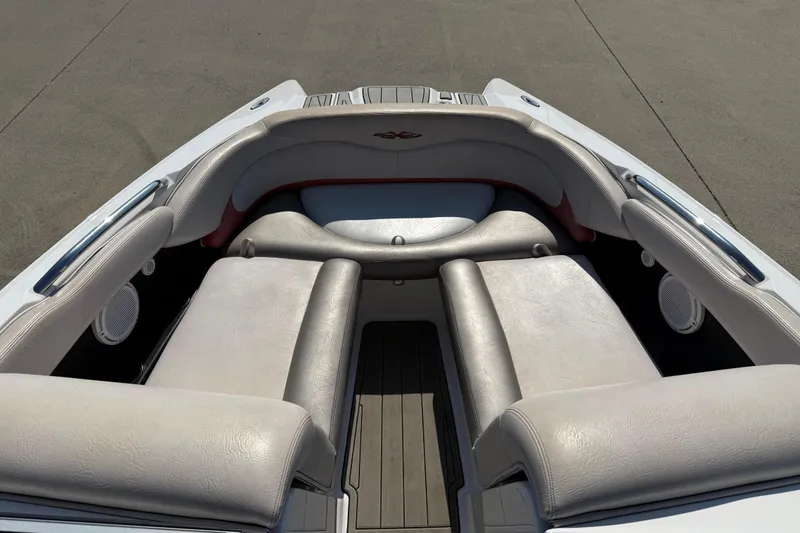 Slide: The Image of 2005 MasterCraft XStar boat interior with cushioned seating and speakers. - 8