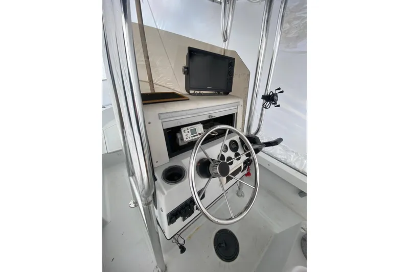 Slide: The Image of 1994 Boston Whaler 19 OUTRAGE boat console with steering wheel and navigation equipment. - 8