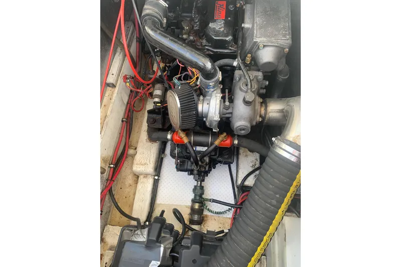 Slide: The Image of Engine compartment of a 1991 Bayliner 3288 Motoryacht, showcasing mechanical components and wiring. - 12