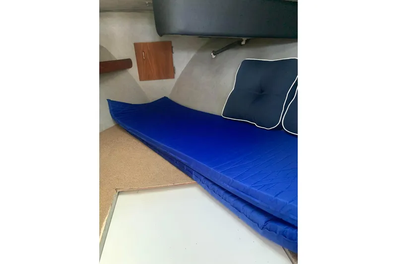 Slide: The Image of 1991 Bayliner 3288 Motoryacht interior cabin with blue bedding and cushions. - 13