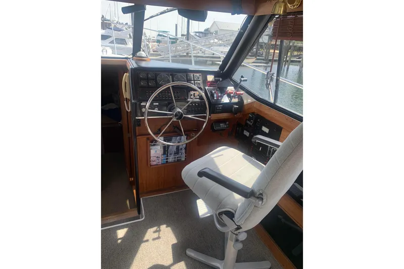 Slide: The Image of 1991 Bayliner 3288 Motoryacht helm with steering wheel and control panel. - 5