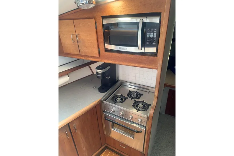 Slide: The Image of Kitchen area of 1991 Bayliner 3288 Motoryacht with stove, microwave, and coffee maker. - 9