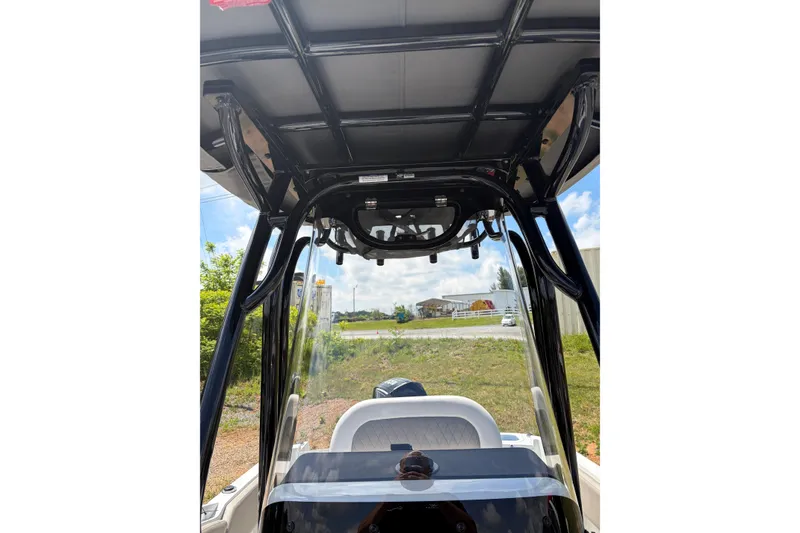 Slide: The Image of 2026 Crownline 210 CC Finseeker boat interior, featuring sleek design and modern canopy structure. - 10