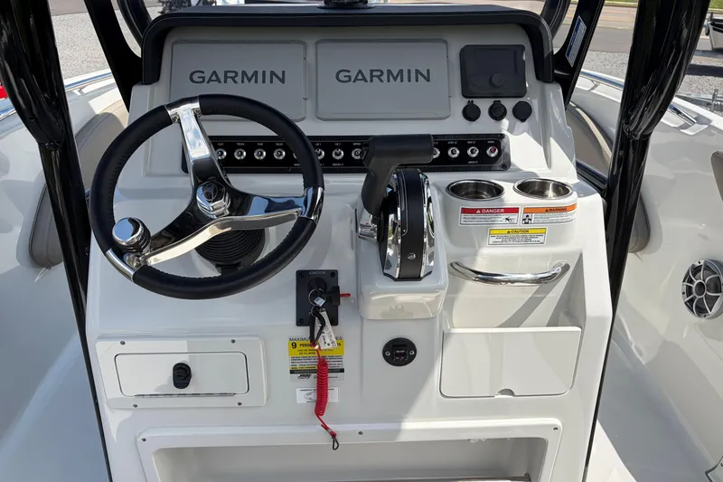 Slide: The Image of 2026 Crownline 210 CC Finseeker boat dashboard with Garmin navigation system and steering wheel. - 12