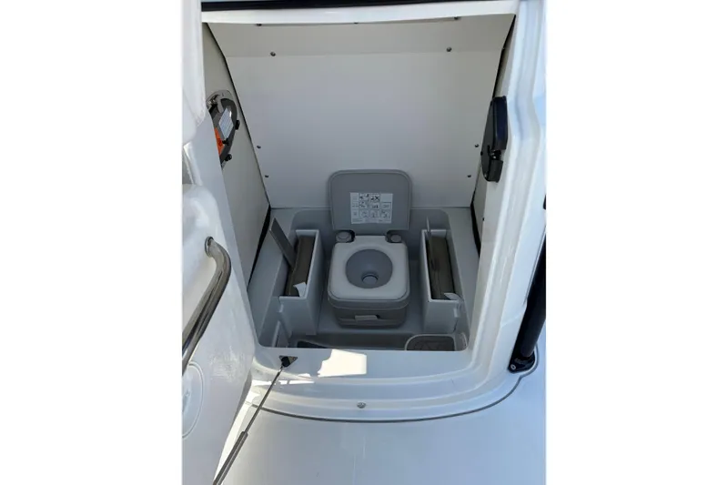 Slide: The Image of Portable toilet inside 2026 Crownline 210 CC Finseeker boat cabin. - 13